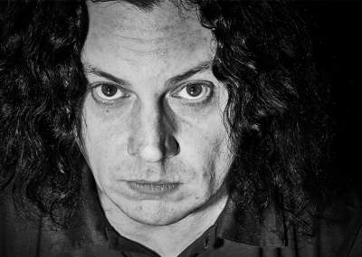 Intensives Schwarz-Weiß-Charakterportrait eines Mannes mit langen Haaren – Fotografie von Anatol Kotte